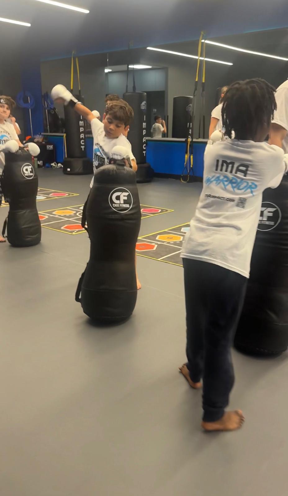 Boys training with punching bags at IMA camp
