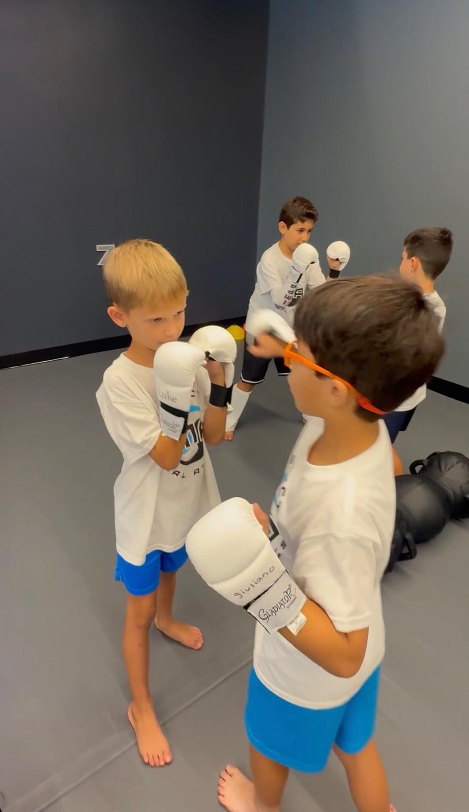 Boys sparring with boxing gloves at IMA camp