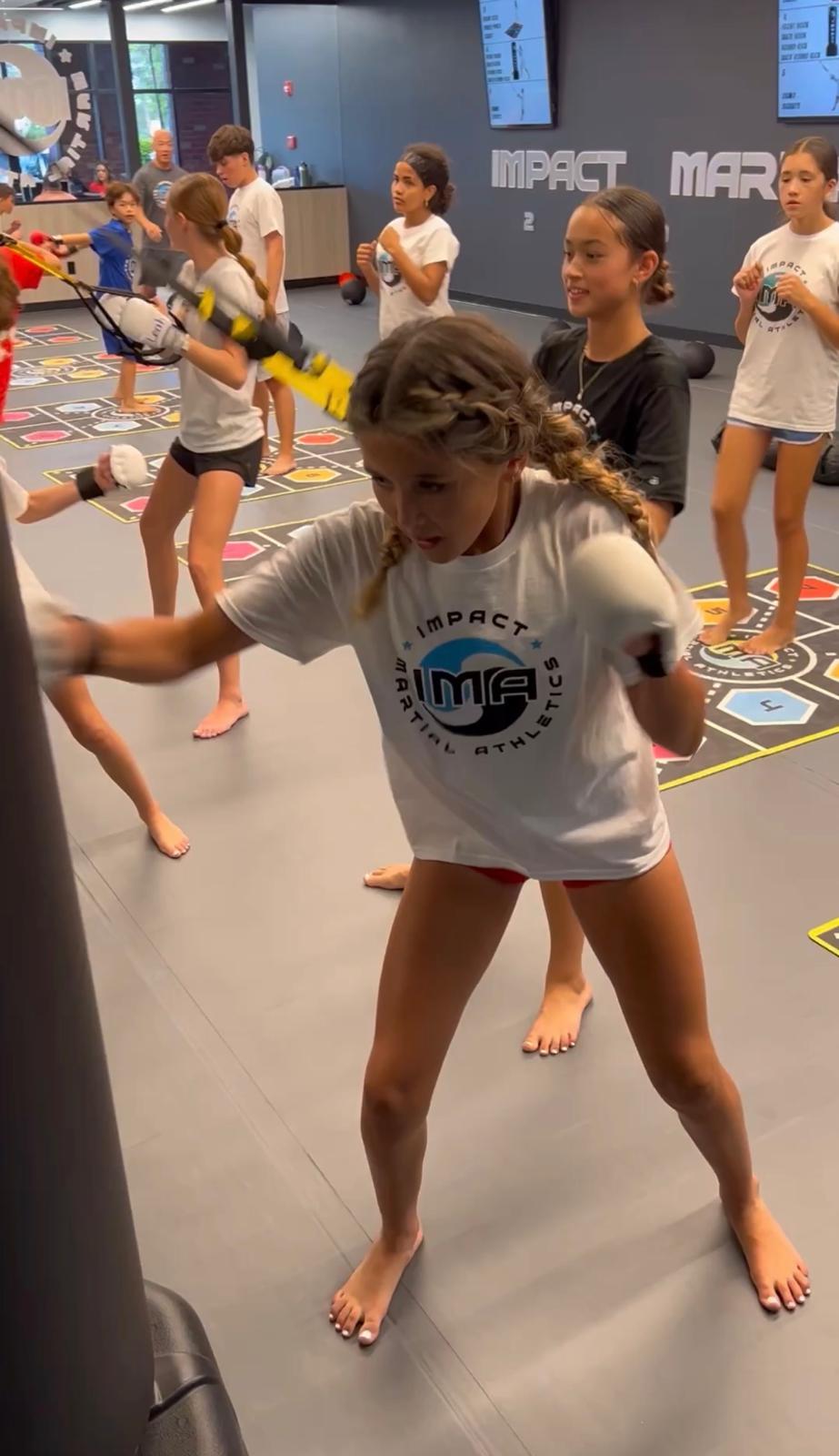 Girl doing TRX resistance training at IMA fitness camp in Davie Florida