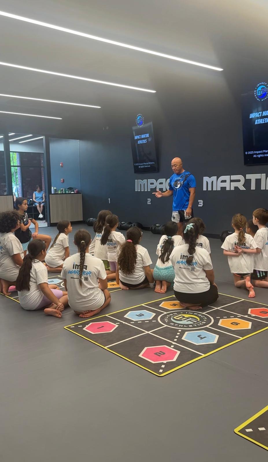 Instructor teaching mindset lesson to kids at IMA